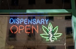 Glowing neon marijuana open sign