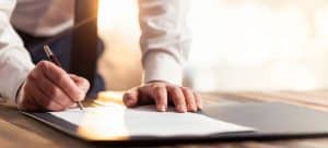 Businessman Signing An Official Document